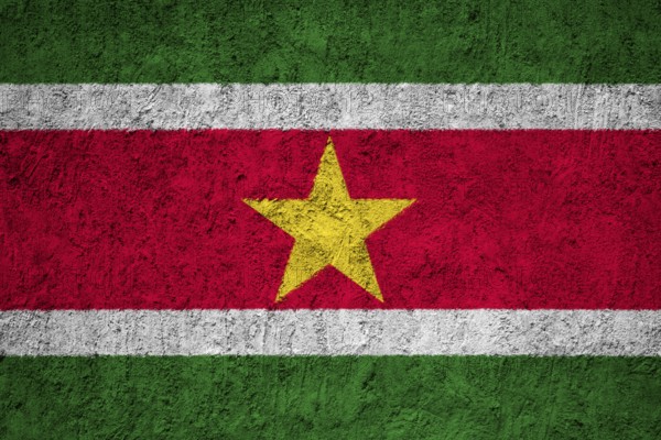 Suriname Flag painted on the cracked grunge concrete wall