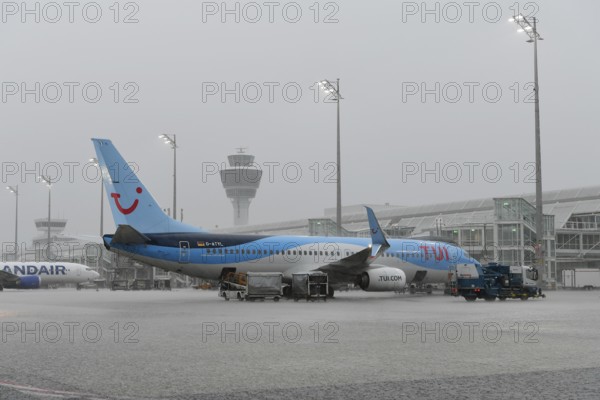 Tui fly Boeing B737-800 on handling position during heavy rain, thunderstorm, rain cloud, storm,