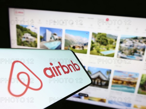 Stuttgart, Germany, 11-30-2022: Smartphone with logo of American homestay marketplace company