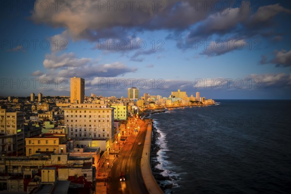 High angle view on Havana malecon coastal road and cityscape during sunset. Travel and tourism