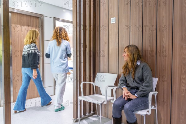 Nurse taking a patient from the waiting room because it was their visiting time
