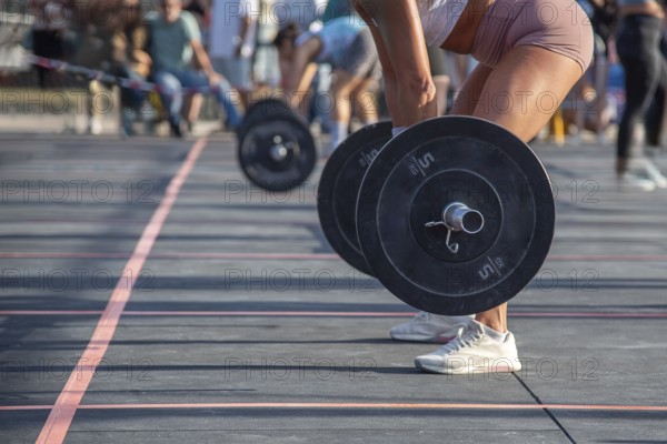 Part of a photo of an intense moment as the athlete prepares to lift the heavy barbell at an