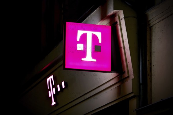 Illuminated sign at a Telekom shop in the city centre of Karlovy Vary in the Czech Republic at