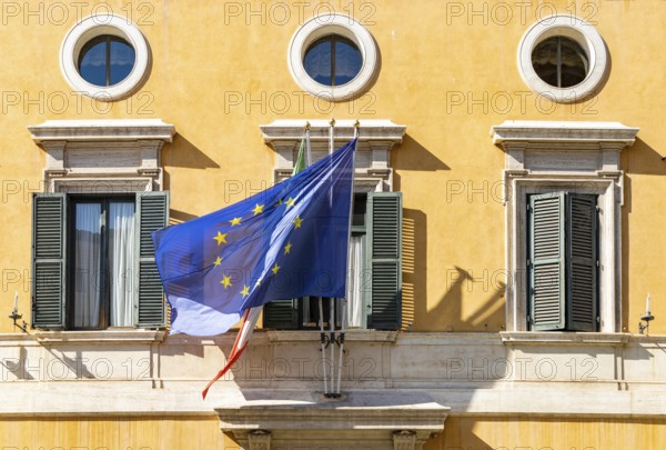 A picture of the Italian and European Union flags on a building facade