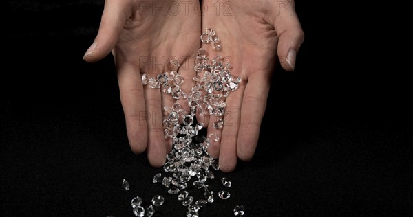 Hand of Woman with Diamonds against Black Background