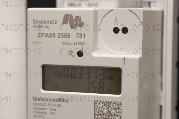 Symbolic image of energy costs in the household, digital electricity meter in a flat, operator