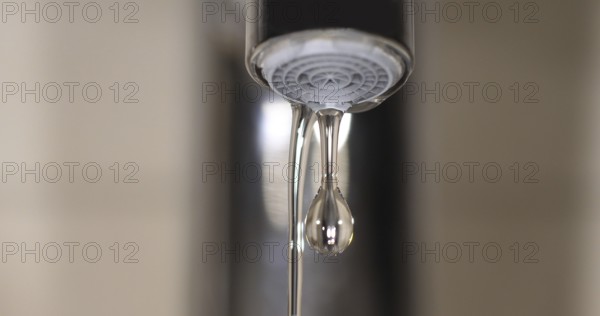 Water Flowing from the Tap, making a drop of water