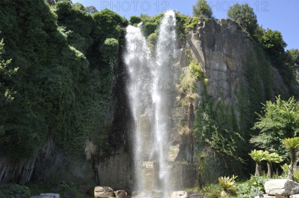 Jardin Extraordinaire, a garden in Nantes, France with a waterfall, rocks and lush vegetation