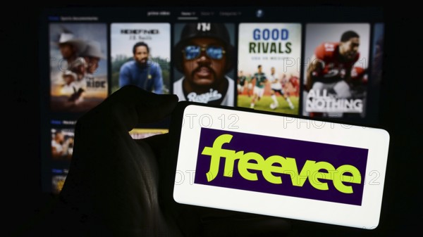 Stuttgart, Germany, 11-11-2023: Person holding cellphone with logo of US video-on-demand streaming