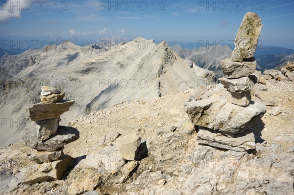 Stone men, Steinmandl at the summit of the Birkkarspitze, behind Ödkarspitzen, Alpenpark Karwendel,