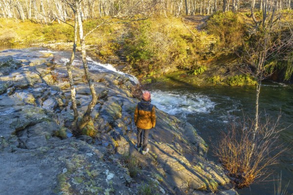 Hiker admiring zaldibartxo waterfall in gorbeia natural park, basque country, a beautiful nature