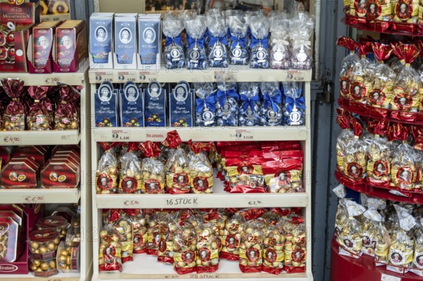 Shelves full of packaged chocolates and sweets in a shop with price labels, Mozartkugeln, Salzburg,