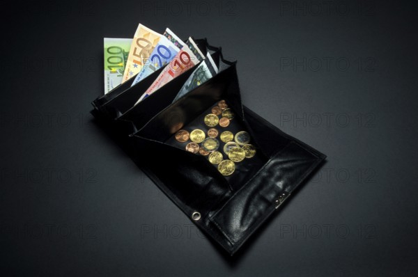 Closeup of a black waiter purse or wallet, small or loose change coins of Euros and Cents, a 5, 10,