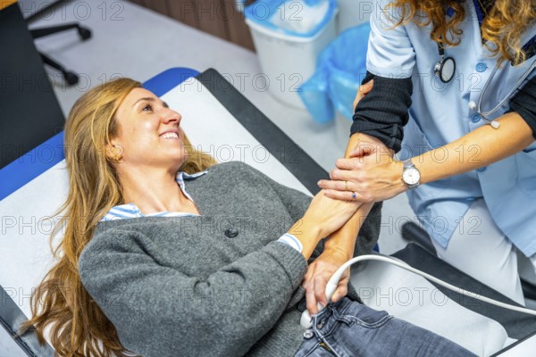 Supportive doctor during a sonogram to a pregnant woman in the hospital