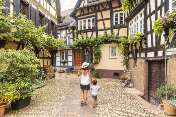 Mother and son in the medieval village in the old town of Gengenbach in the Black Forest, Germany,
