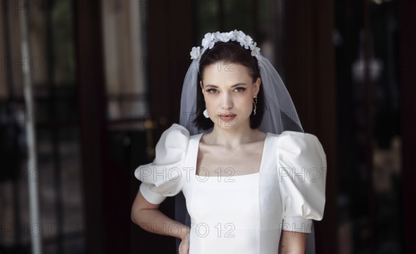 Beautiful young woman bride happy on her wedding day in a white dress and veil