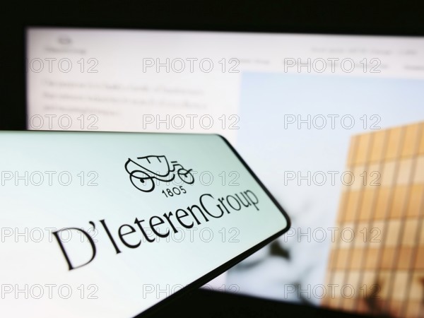 Stuttgart, Germany, 03-18-2023: Cellphone with logo of Belgian automotive company D'Ieteren S.A. on