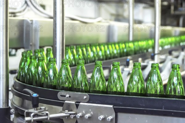 Closeup on mineral water green bottles in raw and lines