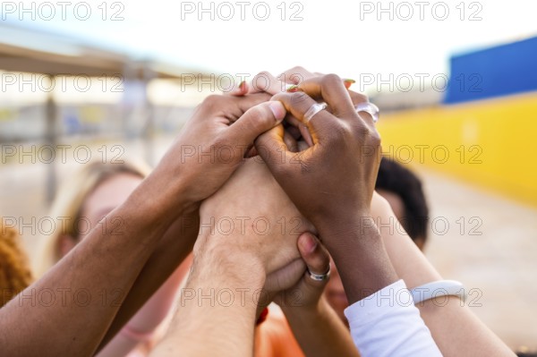 Close-up of hands of multi-ethnic people joining in the air