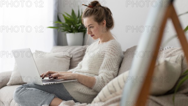 Side view woman writing blog home
