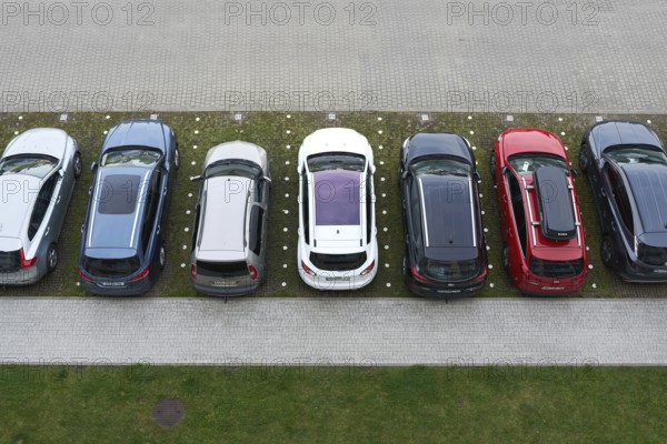 Bird's eye view of a car park with cars in front of a hotel in the town of Kolobrzeg in Poland
