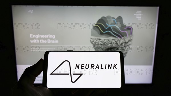 Stuttgart, Germany, 01-30-2022: Person holding mobile phone with logo of US neurotechnology company