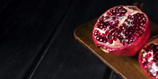 High angle autumn pomegranate halves with copy space