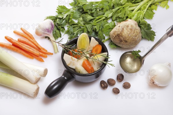 Ingredients for fresh vegetarian vegetable stock, leek, carrots, garlic, celery, onions, nutmeg,
