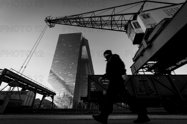 An old harbour crane frames the headquarters of the European Central Bank (ECB) in Frankfurt am