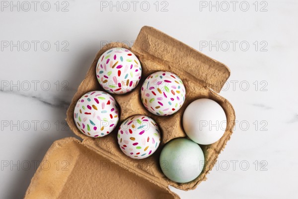 Top view painted easter eggs carton