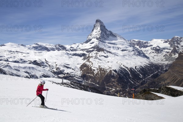 Zermatt, Switzerland, April 12, 2017: A woman skiing in front of the famous Matterhorn, Europe