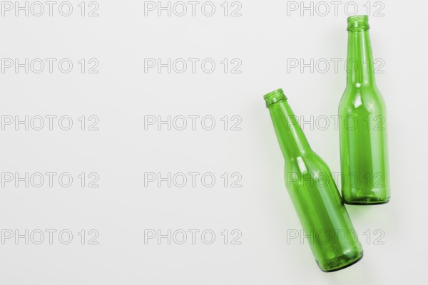 Green empty bottles white background