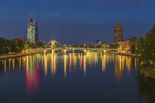View at blue hour of the colourfully illuminated Flößerbrücke, the European Central Bank on the