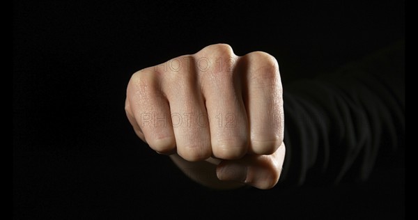 Woman's Fist against Black Background