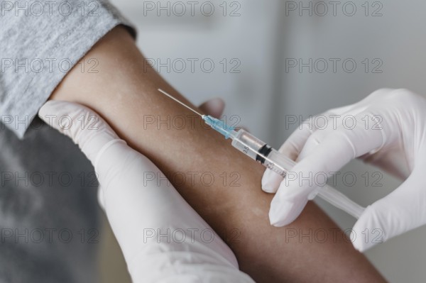 Doctor giving little patient vaccine