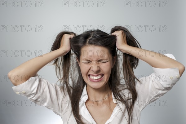 Woman with headache and negative face expression