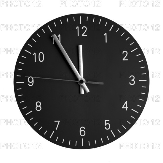 isolated wall clock with its hands at 5 to 12. concept for high time or 5 minutes to midnight