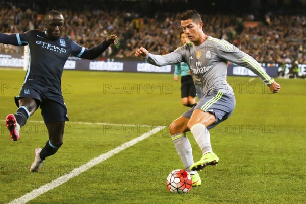 MELBOURNE, AUSTRALIA, JULY 24: Bacary Sagna and Cristiano Ronaldo tussle for the ball as Manchester