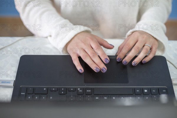 Brunette blogger writing laptop