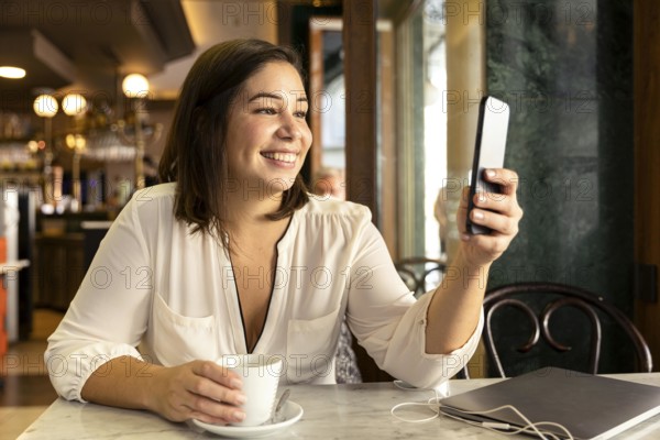 Pretty teenager browsing her mobile phone