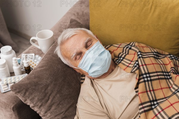 High angle man sleeping with mask