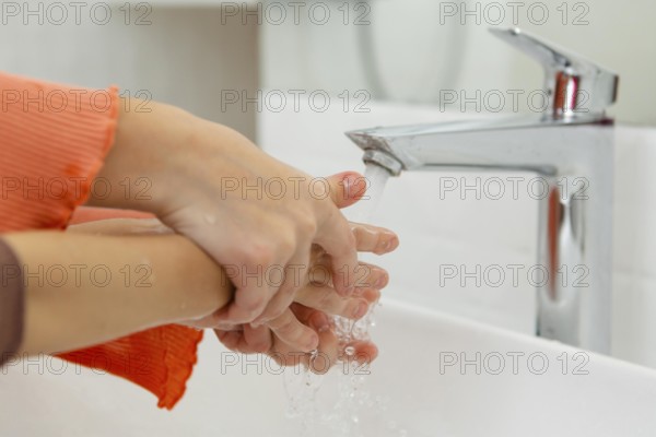Little kids washing their hands close up
