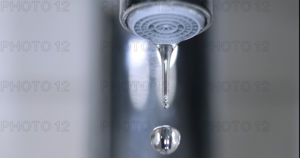 Water Flowing from the Tap, making a drop of water