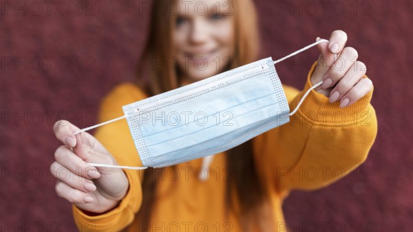 Woman holding medical mask