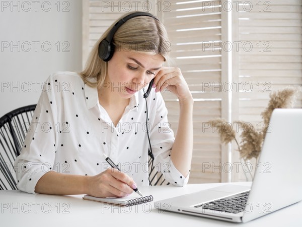 Smart young student thinking her notes