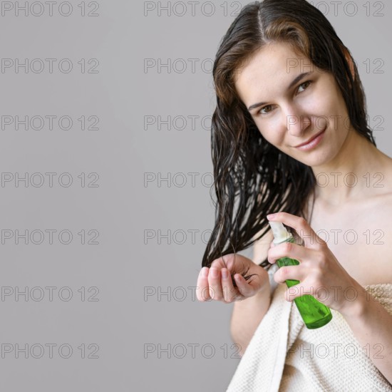 Portrait female using hair oil