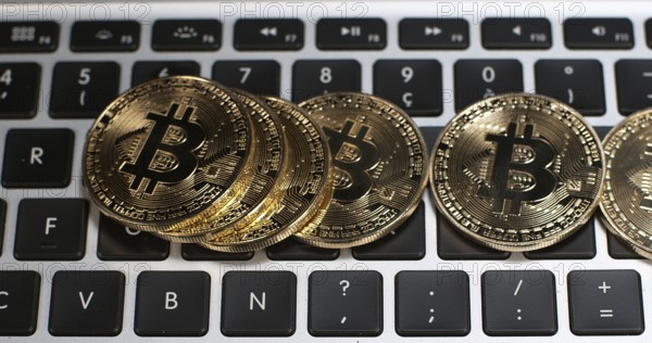 Bitcoins on Computer Keyboard Background