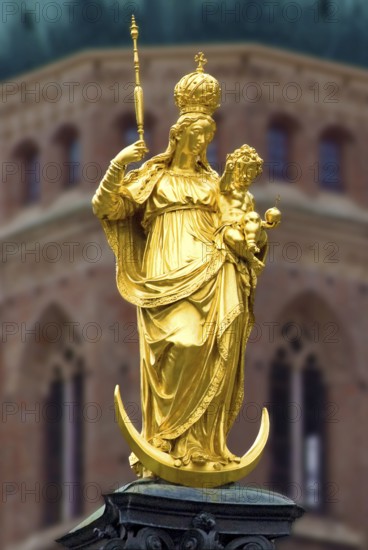 Golden Statue of Virgin Mary with Jesus as a child, a tower of catholic church Liebfrauendom or
