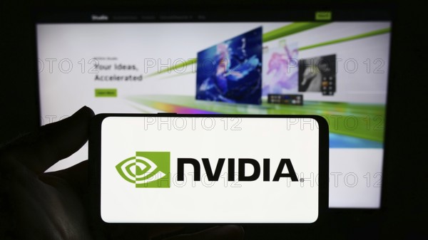 Stuttgart, Germany, 08-13-2023: Person holding smartphone with logo of US technology company Nvidia