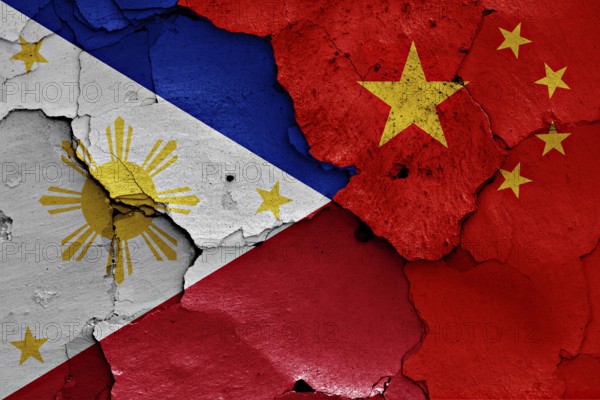 Flags of Philippines and China painted on cracked wall